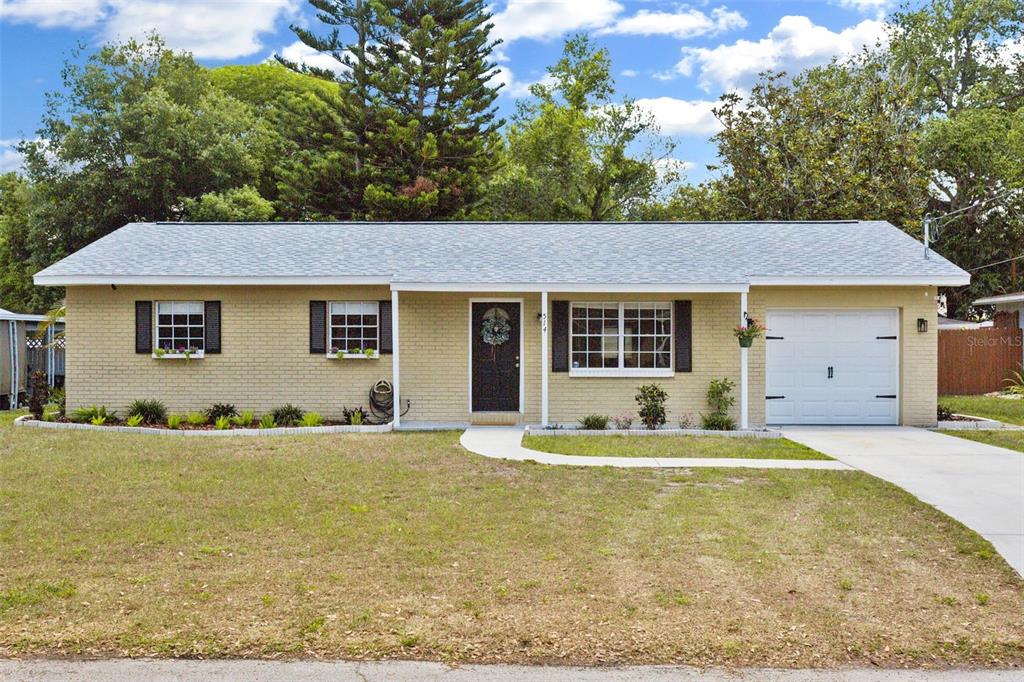 a house that has a tree in front of it