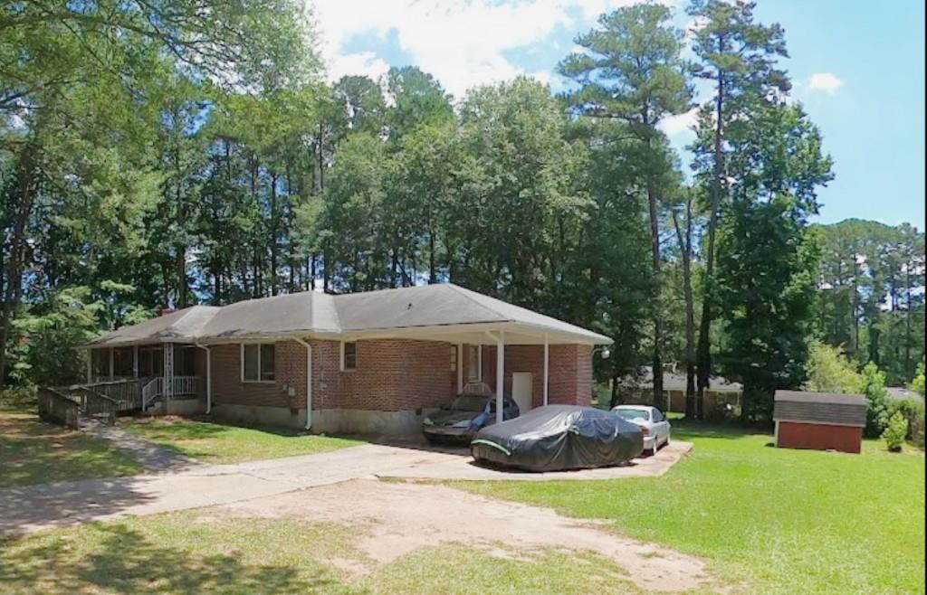 a front view of a house with a yard and porch