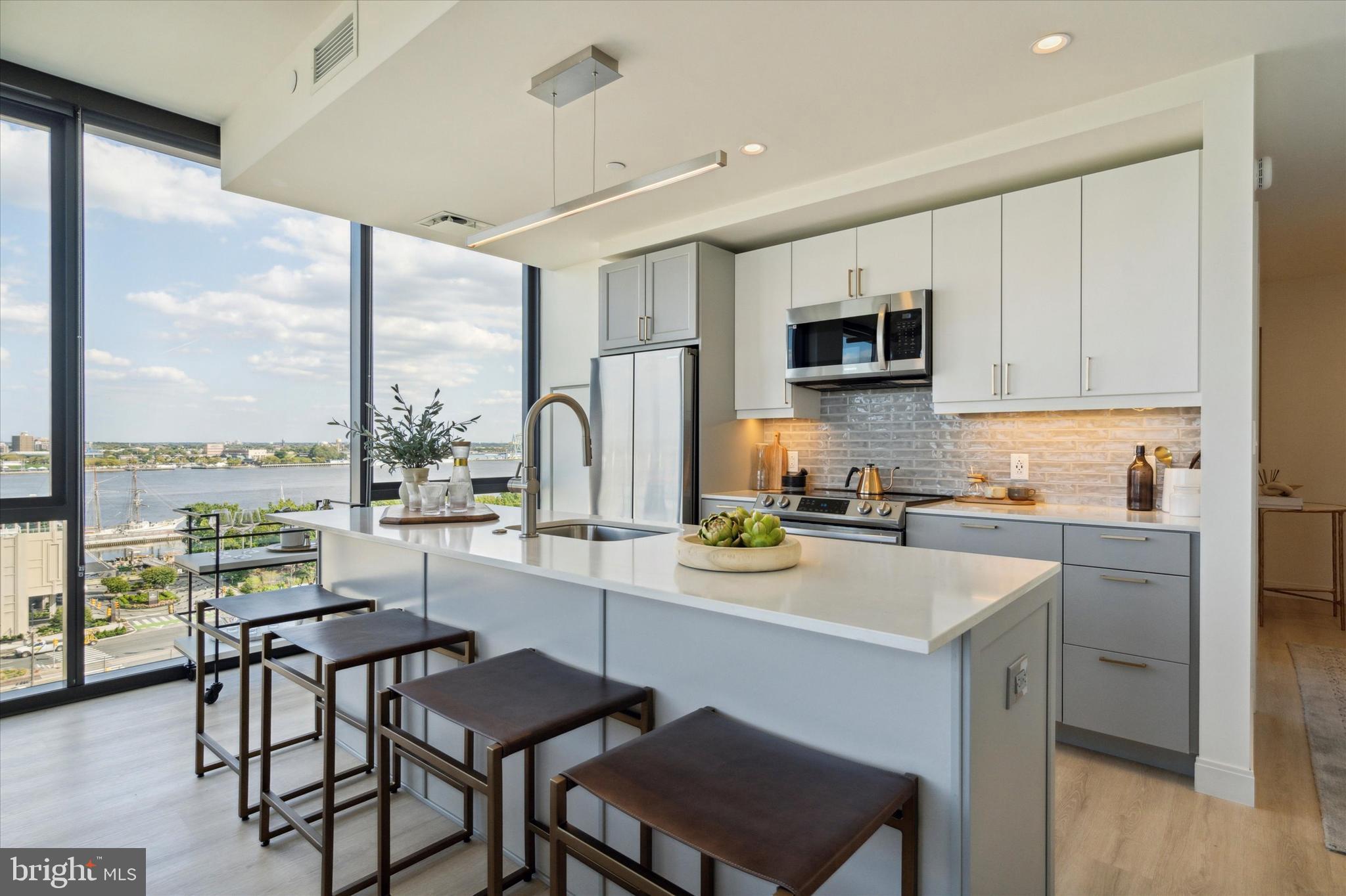 a kitchen with a sink cabinets and wooden floor