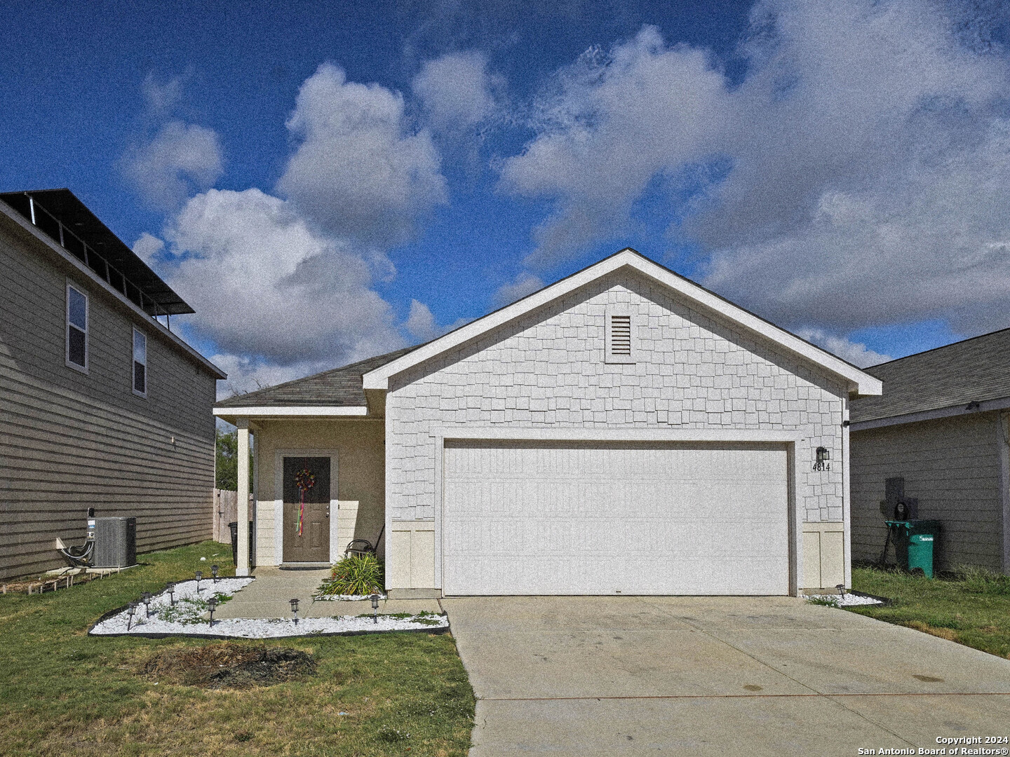 a front view of a house with garden