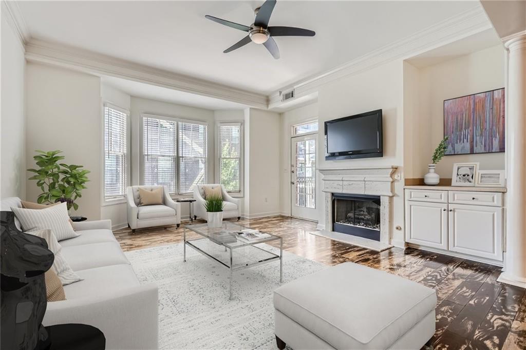 a living room with furniture a fireplace and a flat screen tv