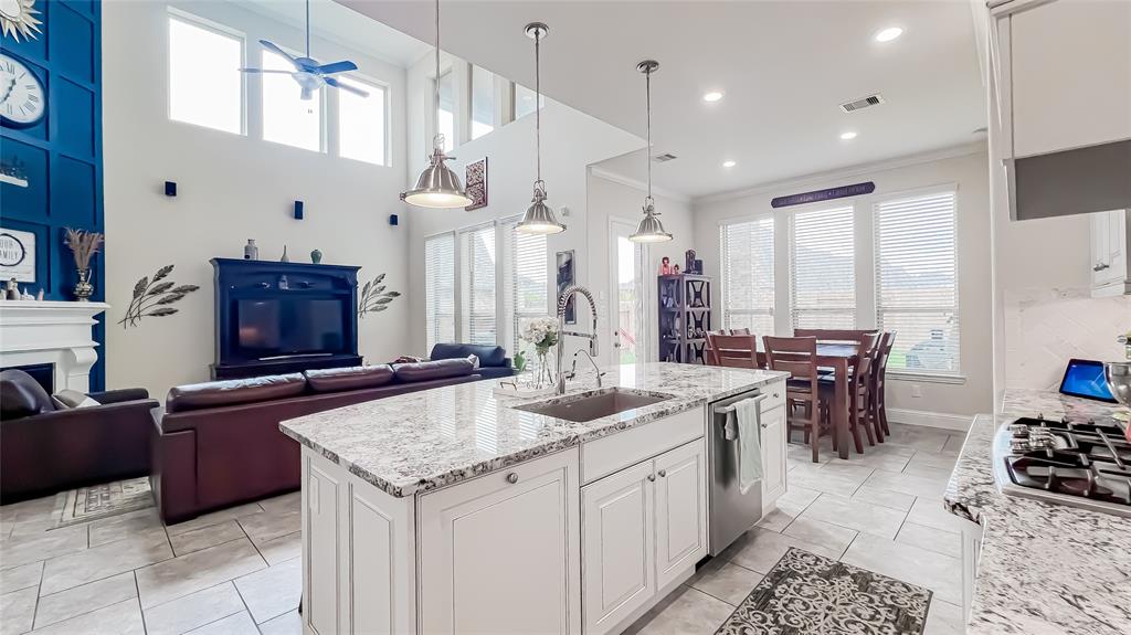 a large kitchen with kitchen island a sink a counter space and stainless steel appliances