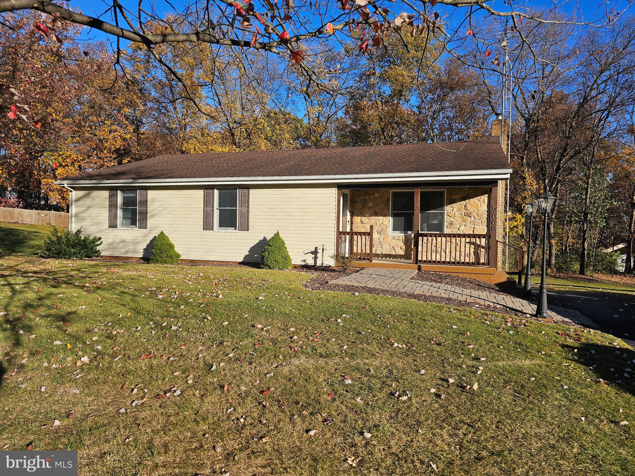 a view of a house with backyard and a tree