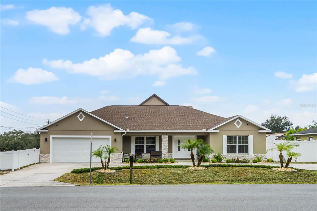 a front view of a house with a garden