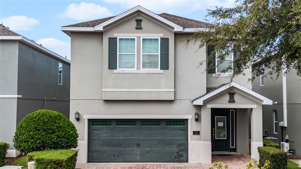 a front view of a house with garage