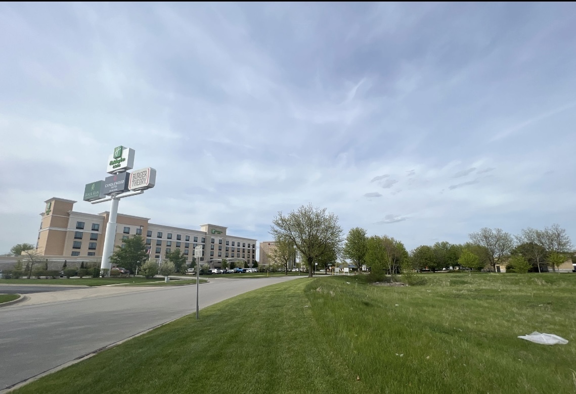 a view of a big house with a big yard and a large parking space