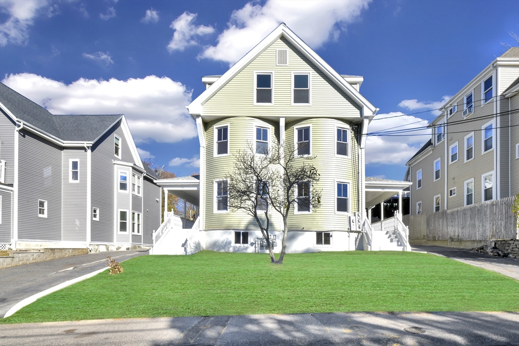 a front view of a house with a yard