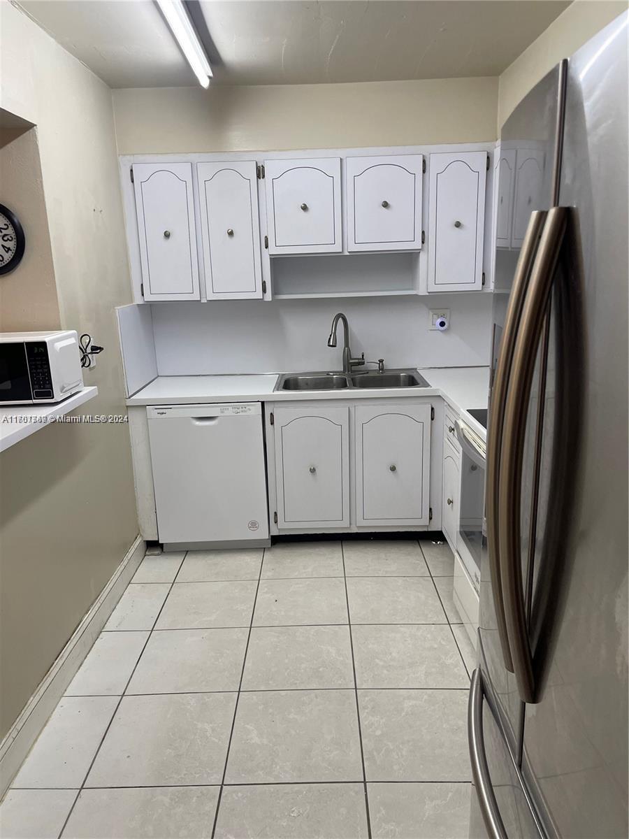 a kitchen with cabinets and steel stainless steel appliances