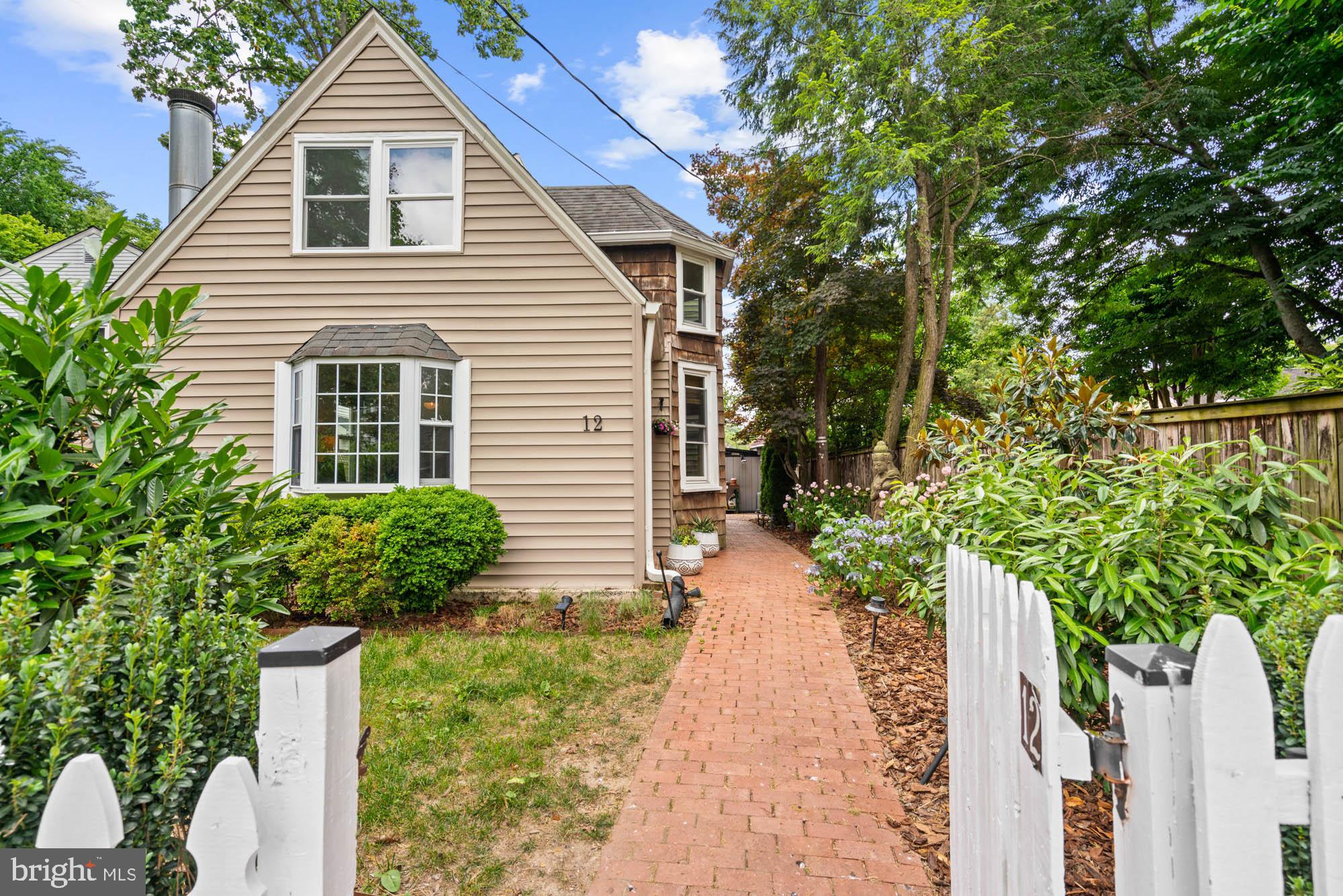 a house with a yard and potted plants