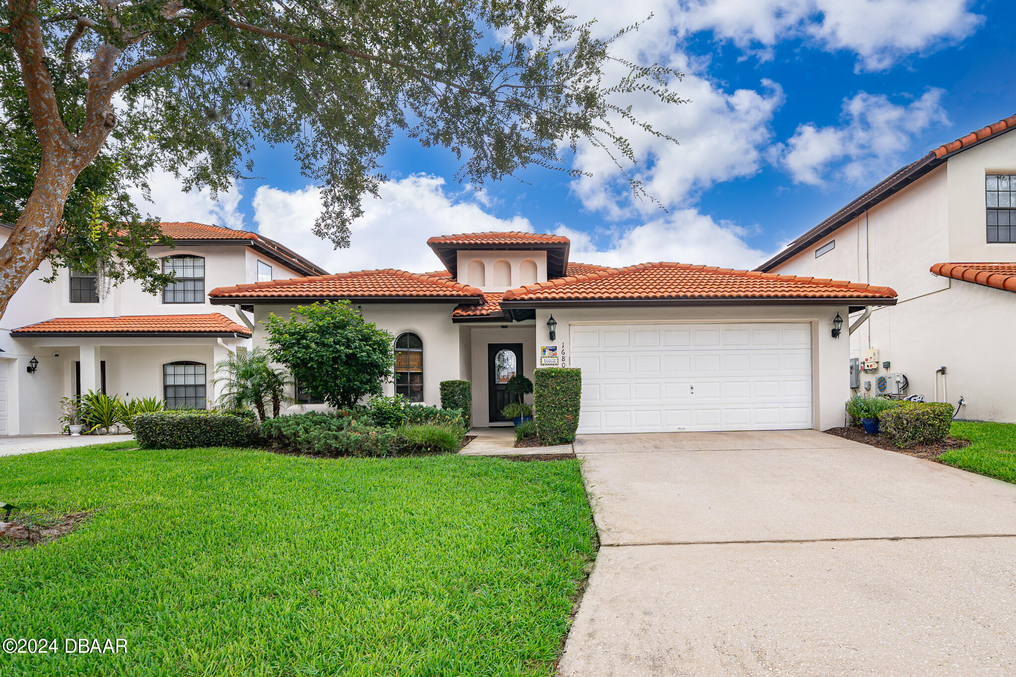 a front view of a house with a yard and garage