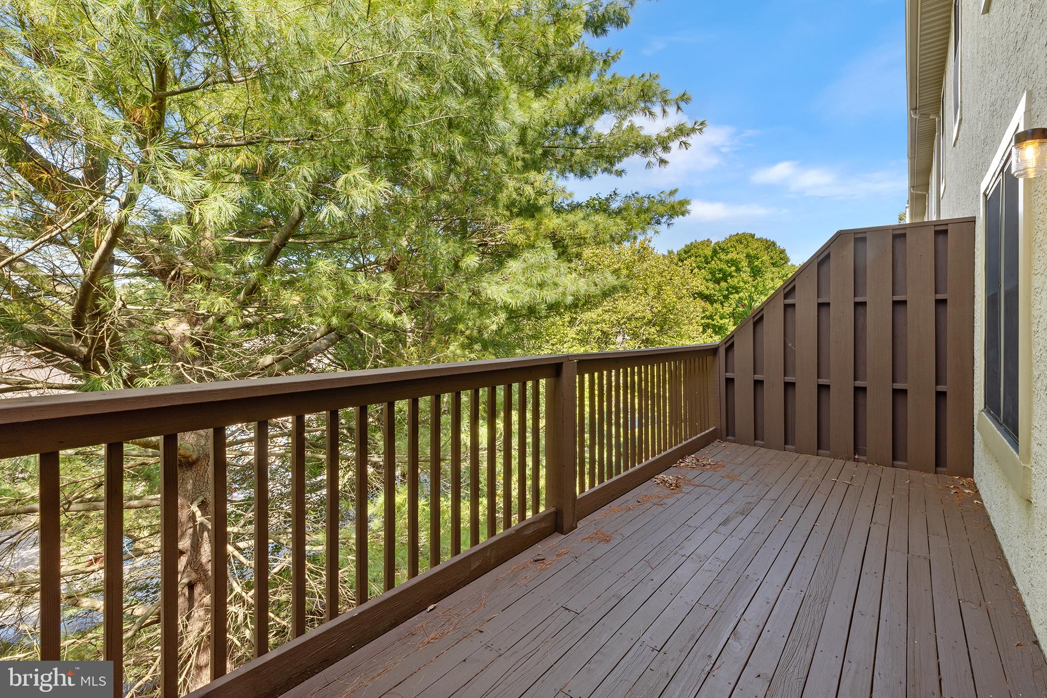 a balcony with wooden floor and fence