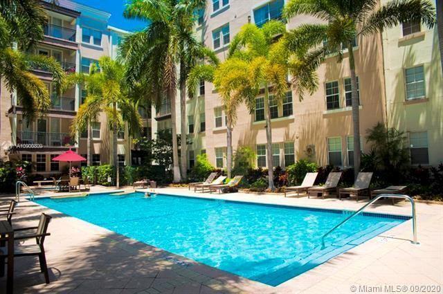 a view of a swimming pool with chairs and tables in the patio