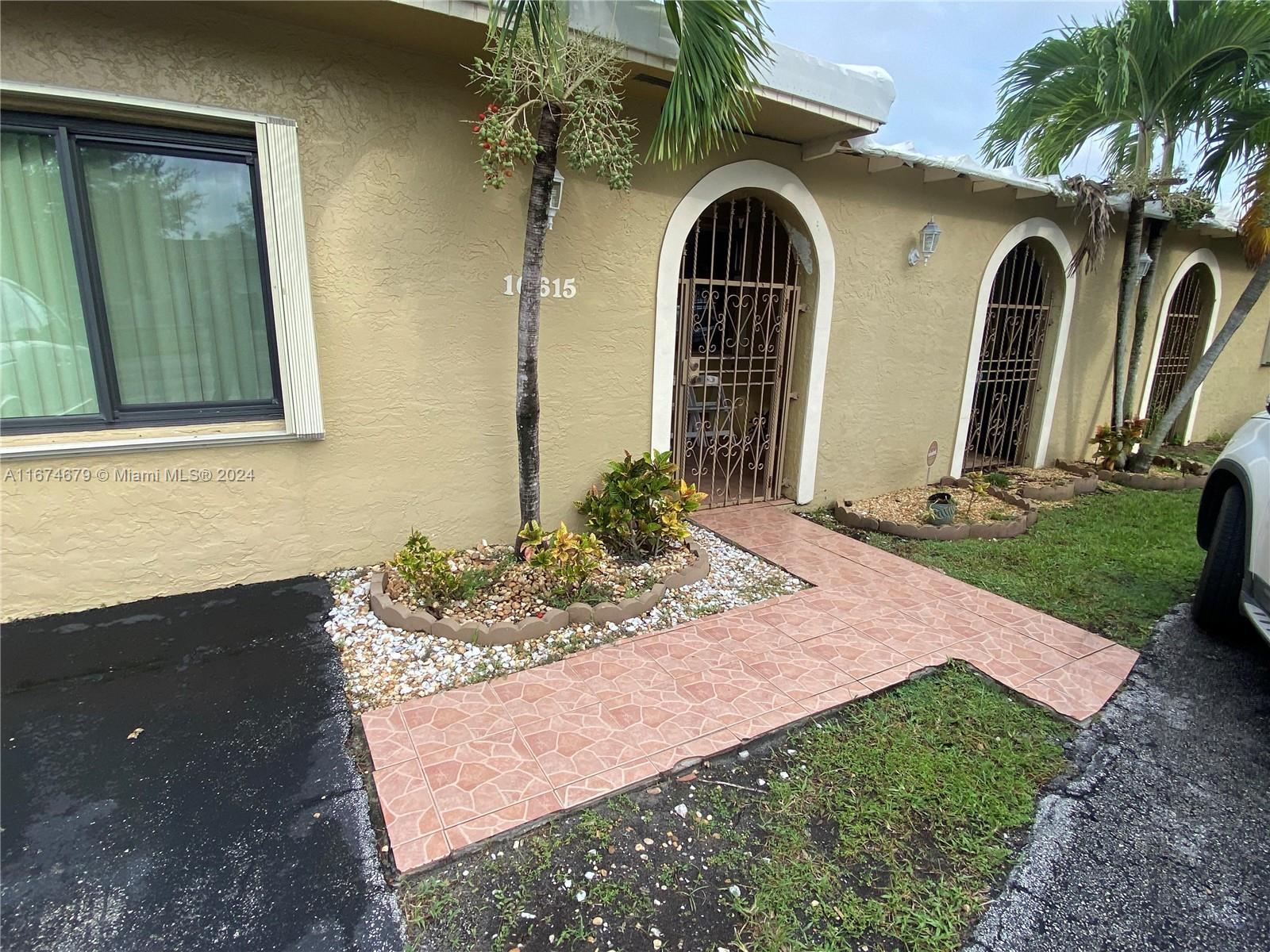 a front view of a house with garden