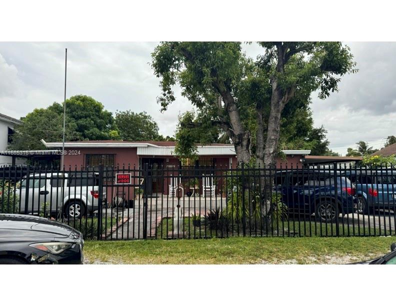 a view of a house with a fence