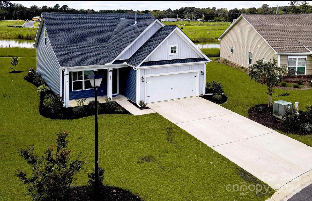 a aerial view of a house with a yard