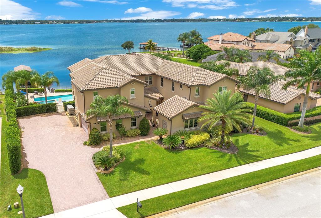 an aerial view of a house with a garden and lake view