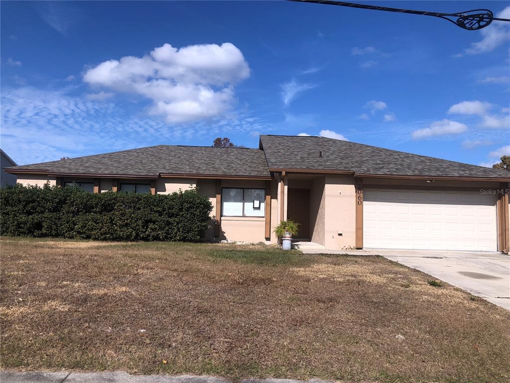 a view of a house with a yard and garage