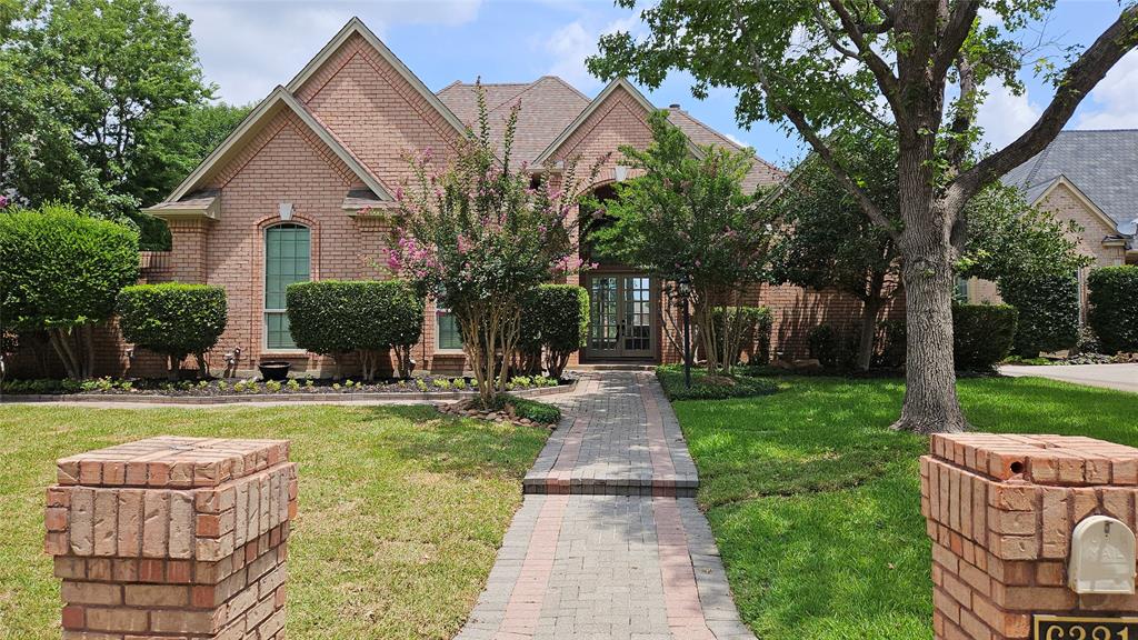 a front view of house with a garden and patio