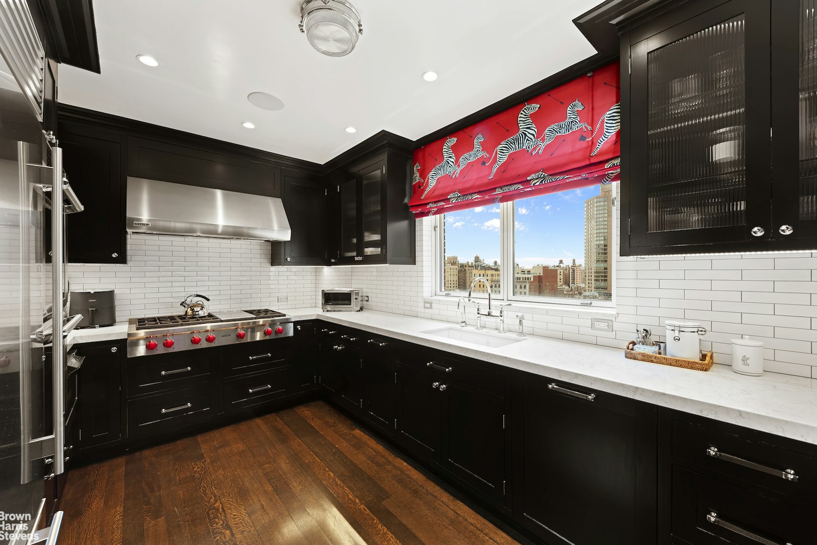 a kitchen with granite countertop a sink cabinets and window