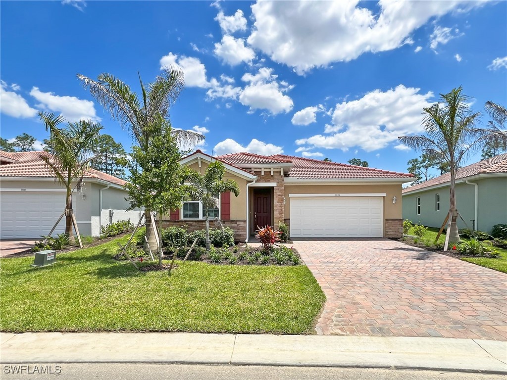 a front view of a house with a yard and garage