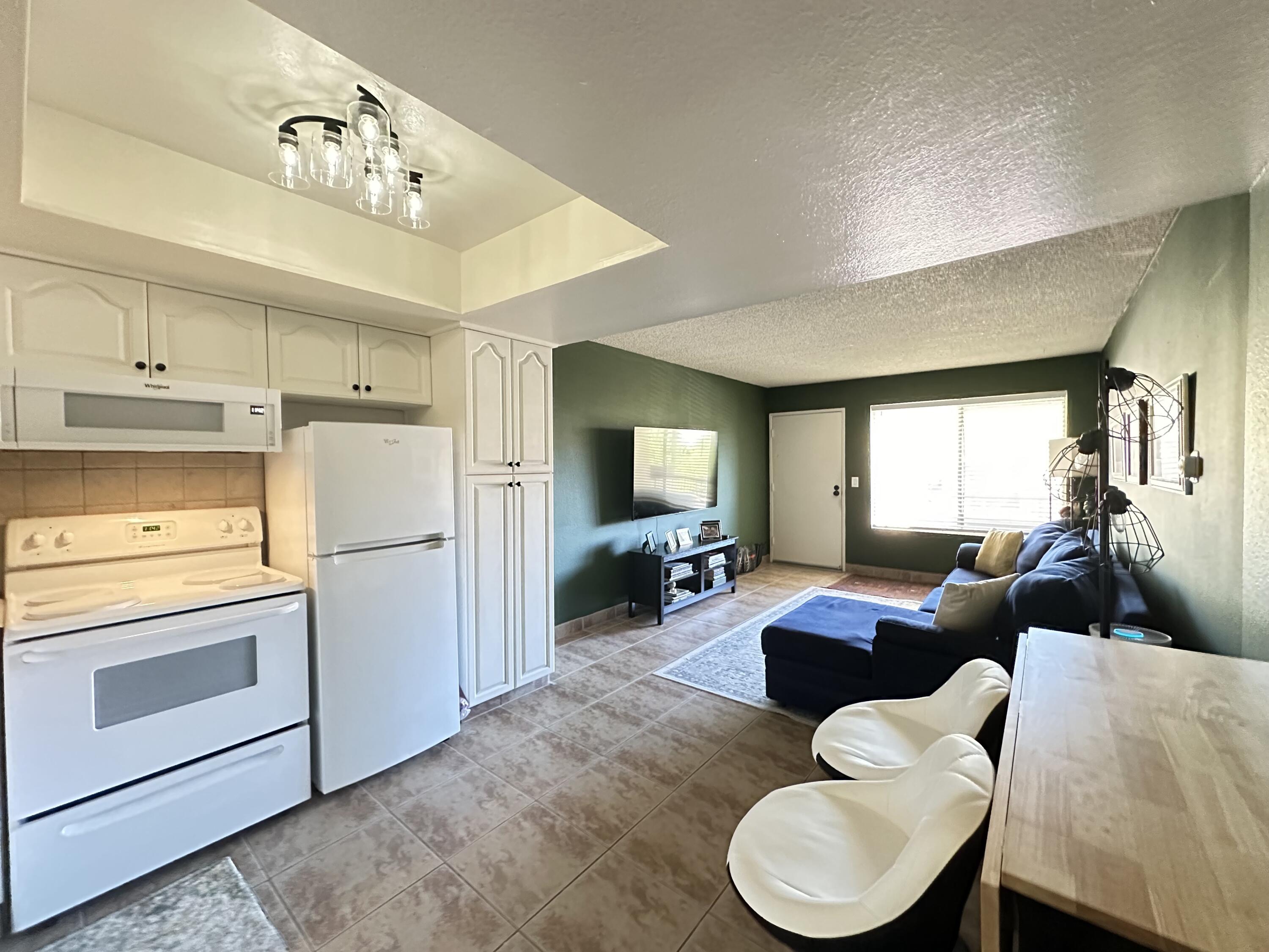 a living room with furniture and kitchen view