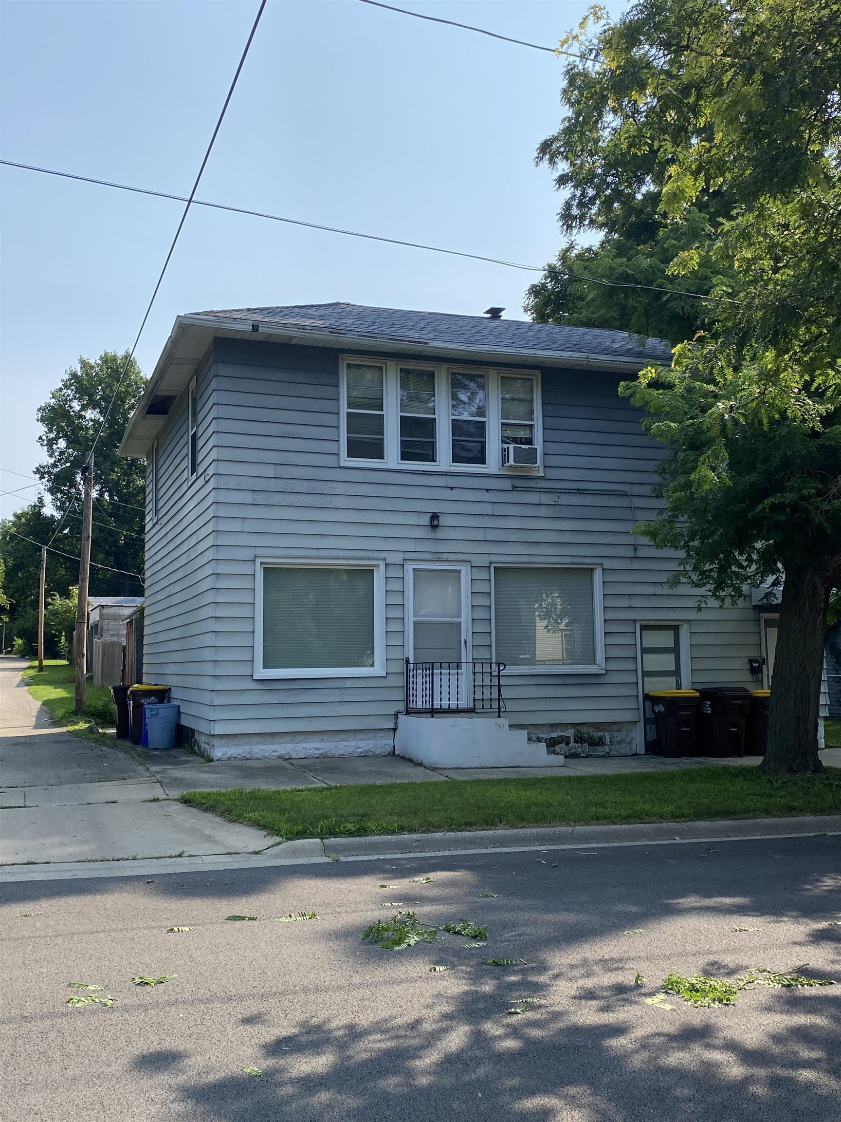 a view of a brick house with a yard