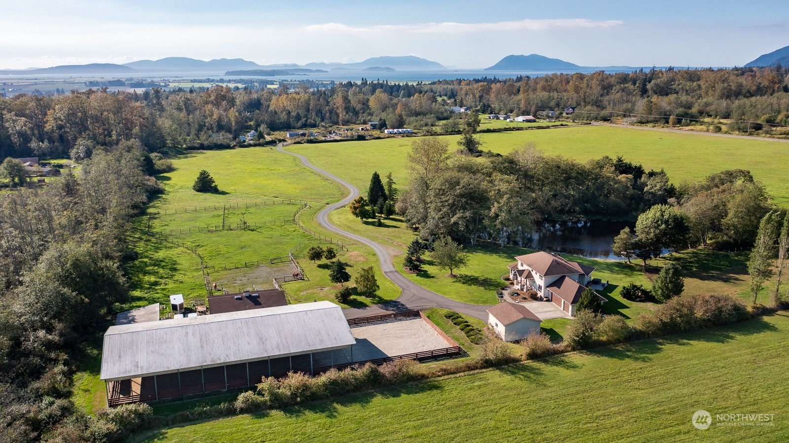 an aerial view of a house with a garden and lake view