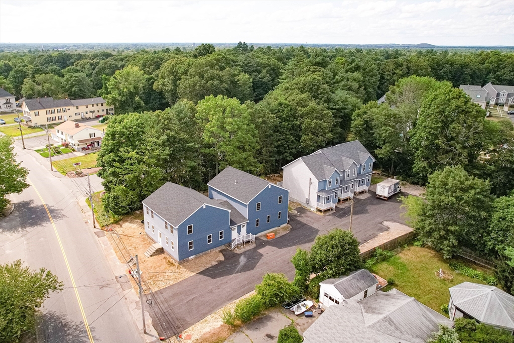 an aerial view of a house with yard and outdoor seating