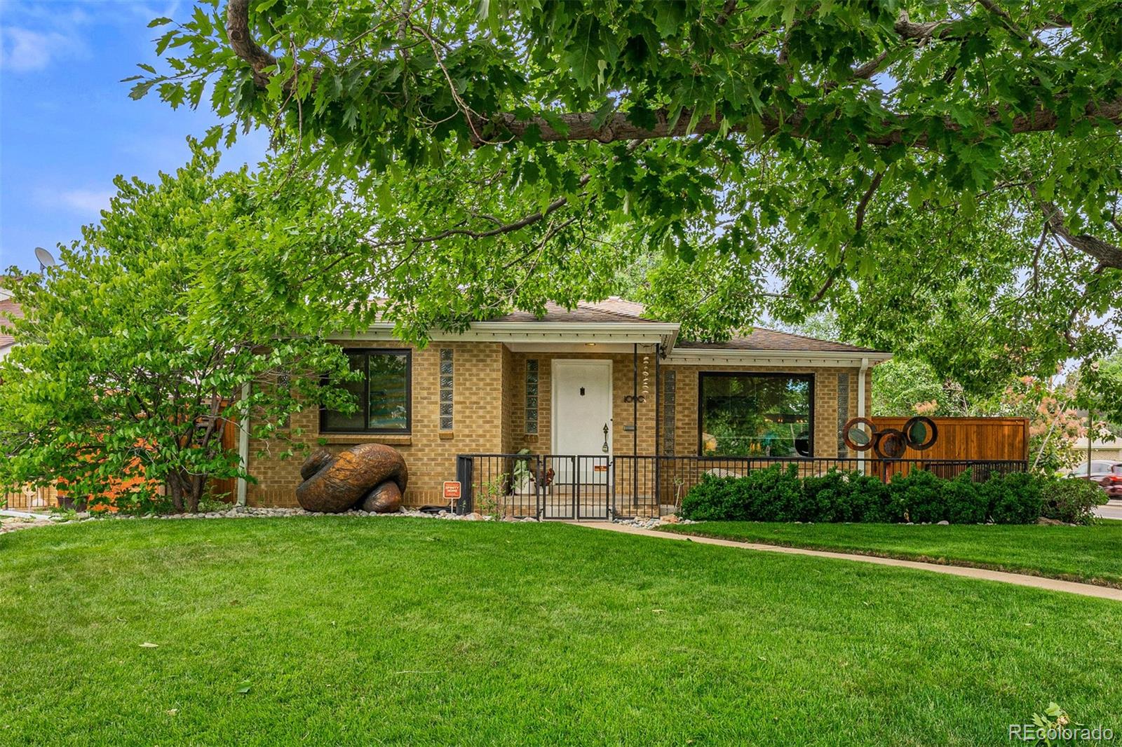 a view of a house with a backyard and a garden