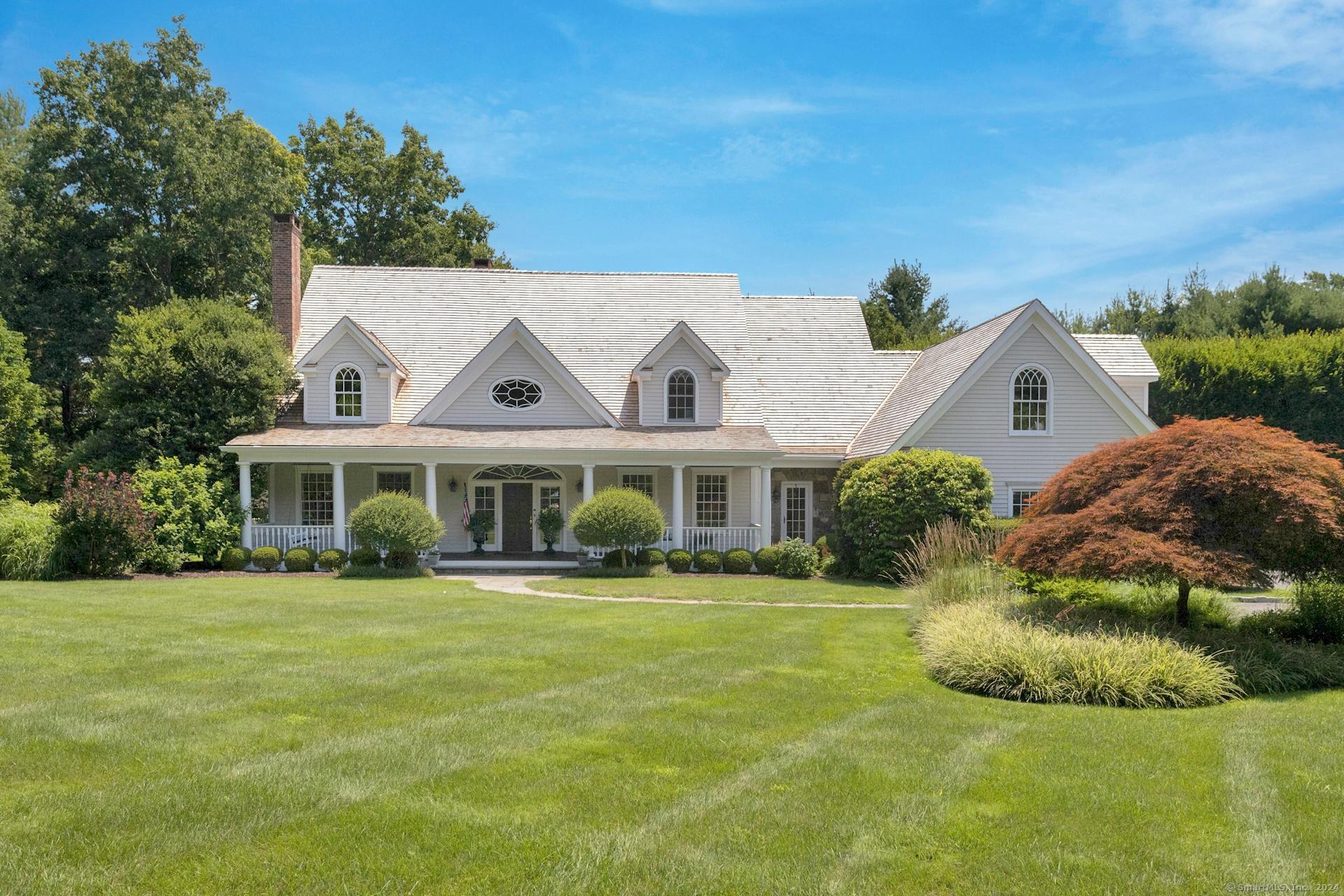 a front view of a house with a garden