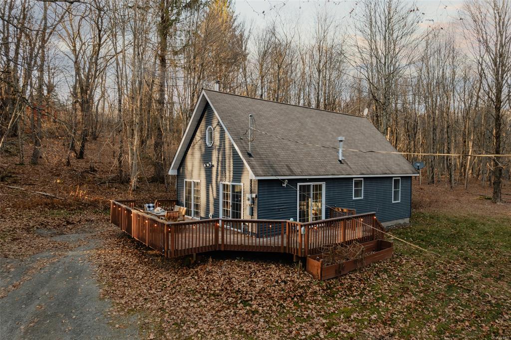 Rear view of house with a wooden deck