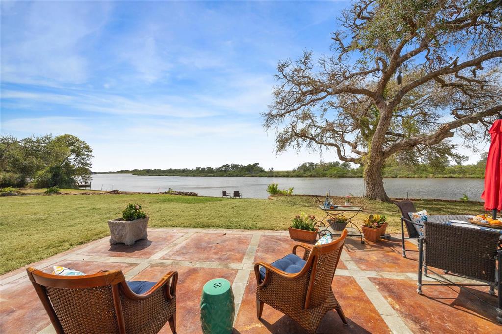 a view of a lake with a table and chairs