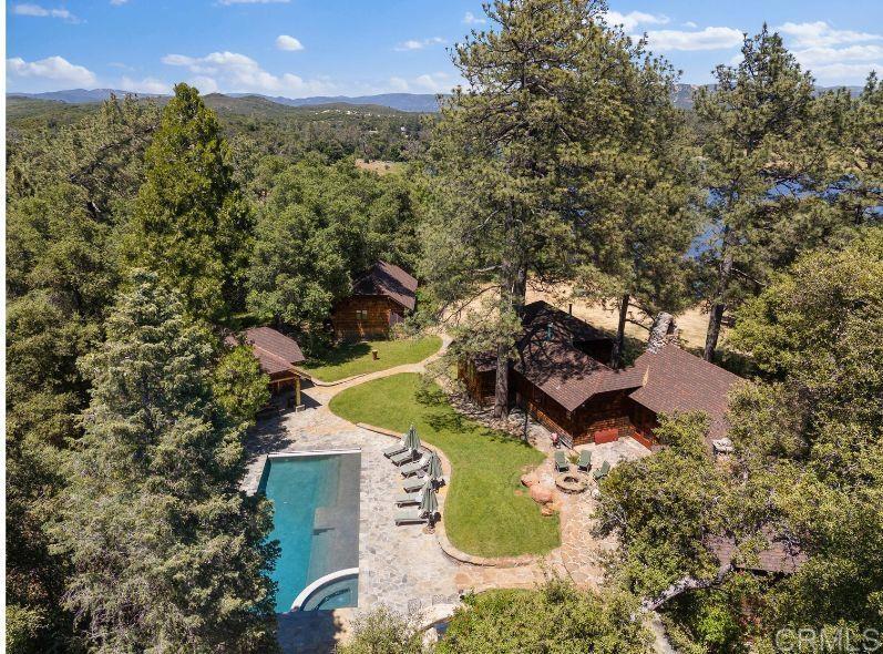 an aerial view of a house with yard swimming pool and outdoor seating