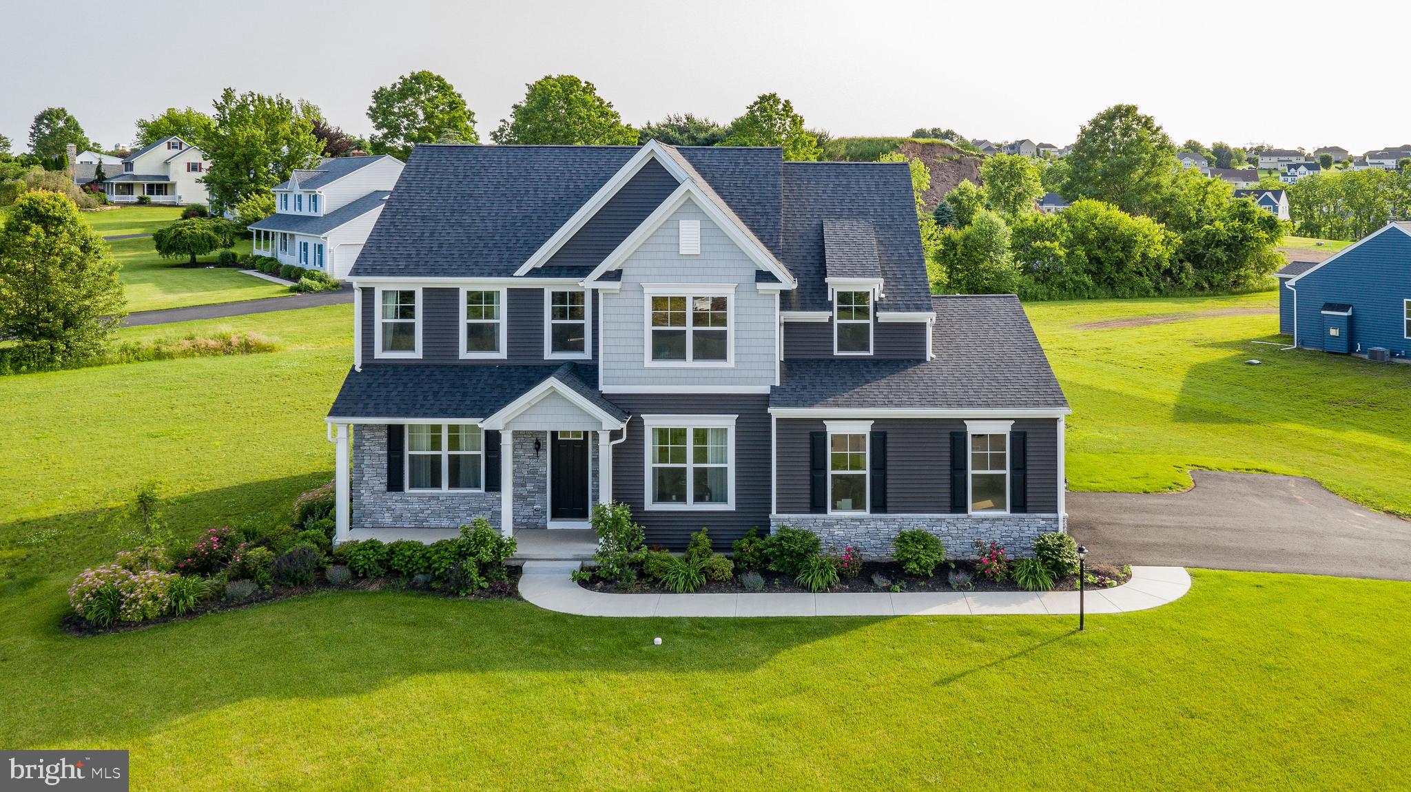 a front view of house with yard and green space