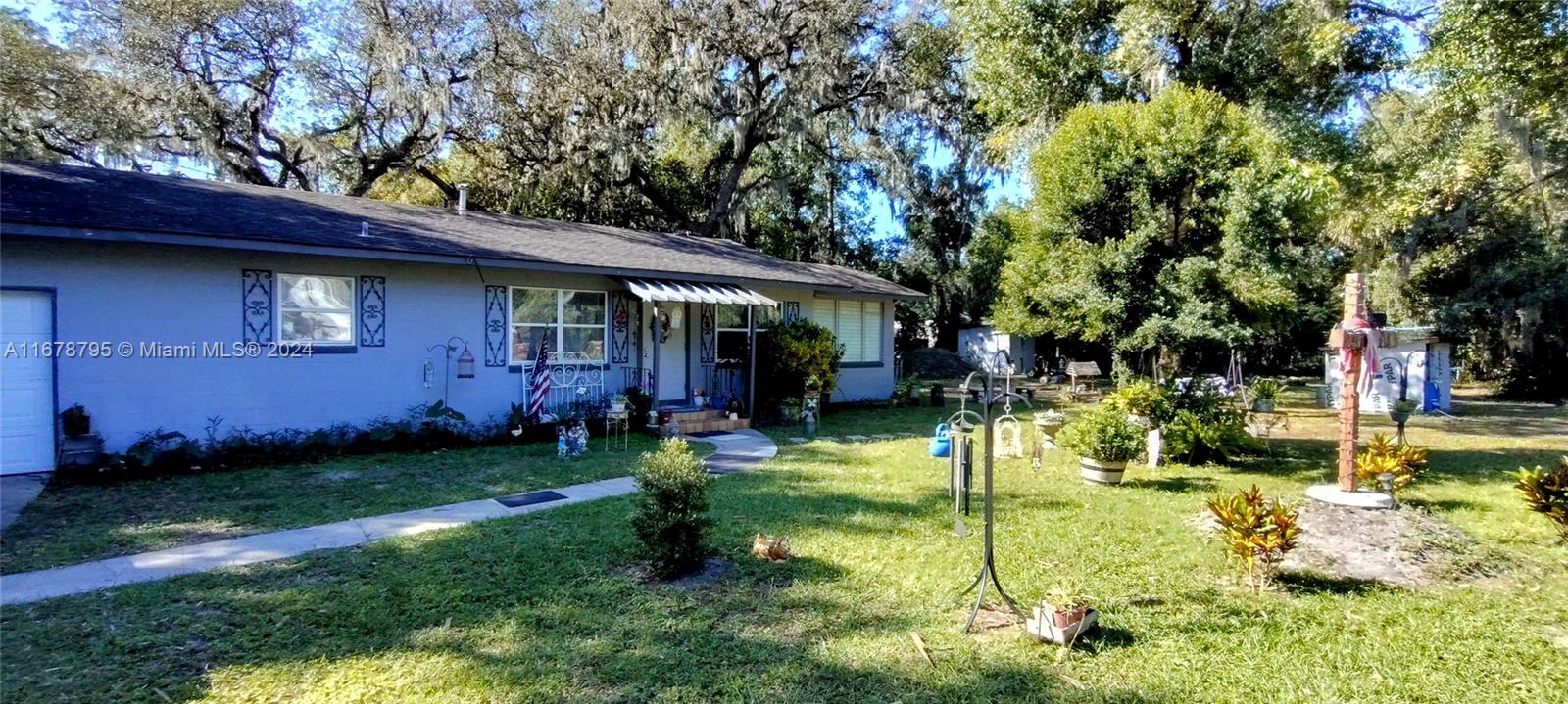 a view of a house with backyard porch and sitting area