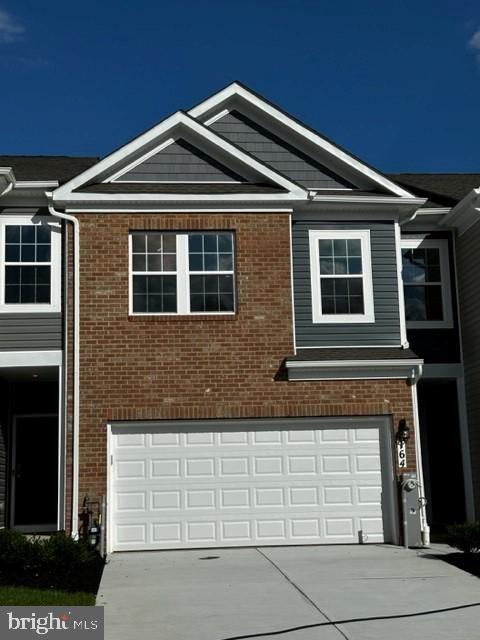 a front view of a house with garage