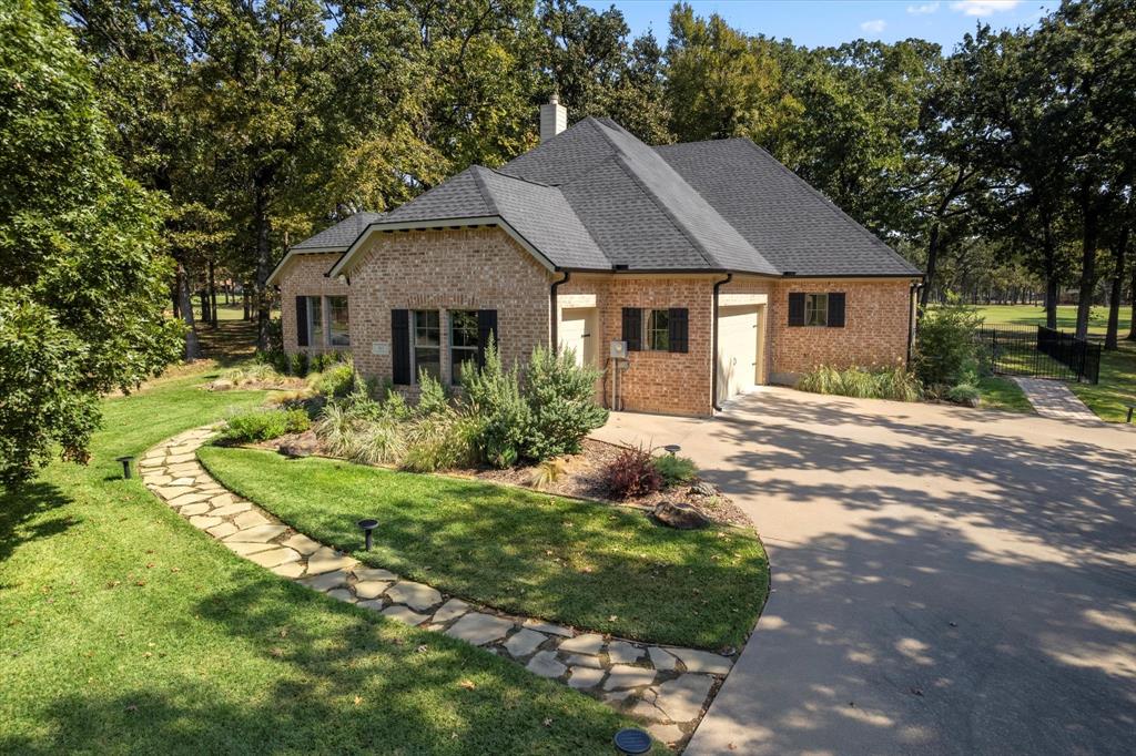 a front view of house with yard and trees