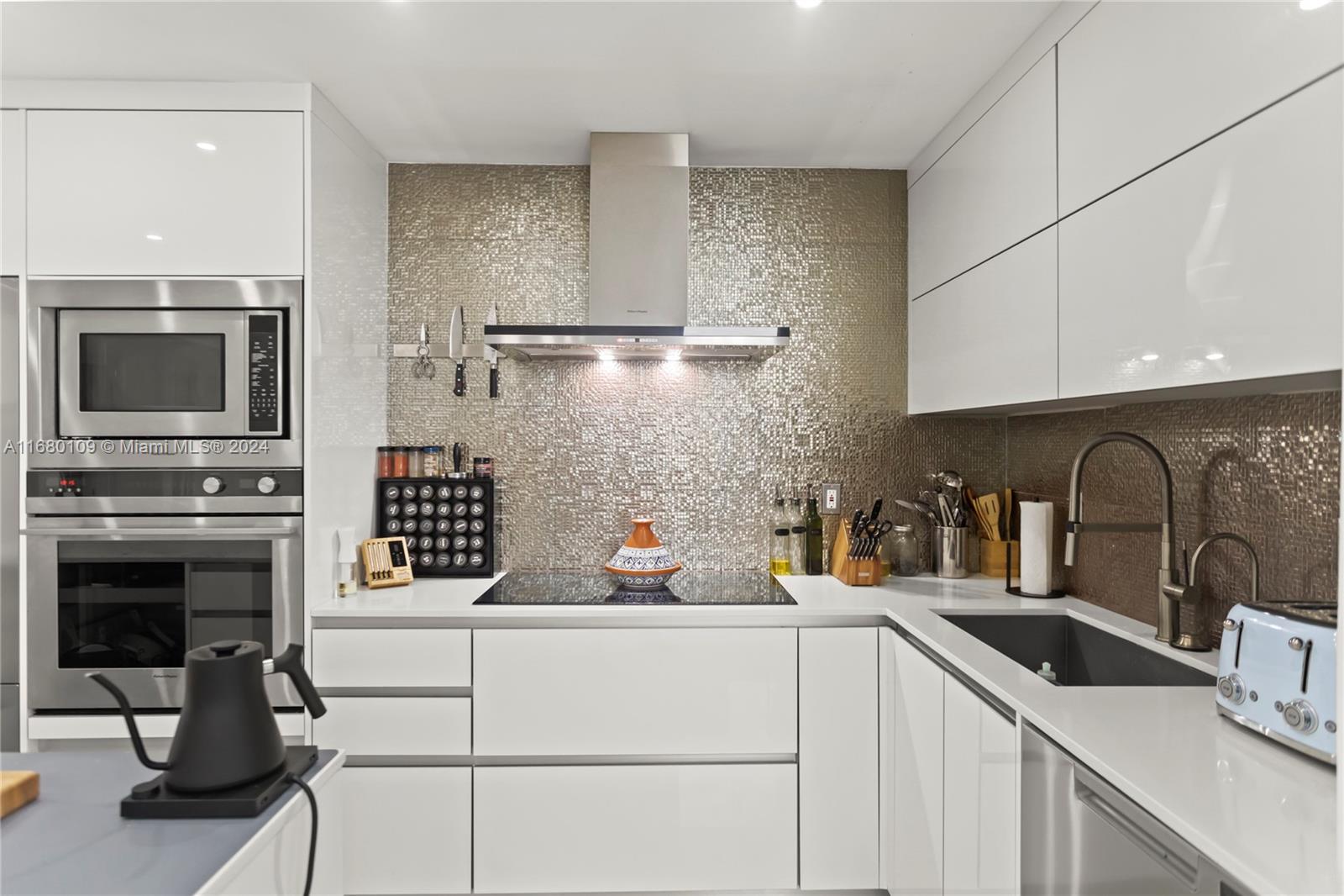 a kitchen with a sink cabinets and appliances