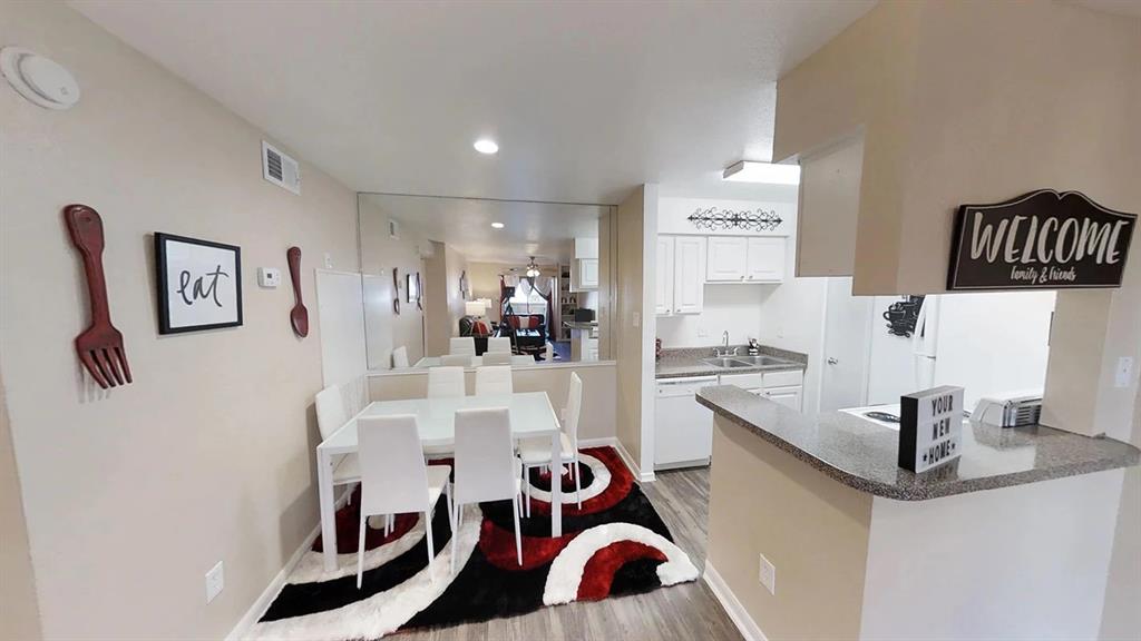 a kitchen with stainless steel appliances granite countertop a sink and refrigerator