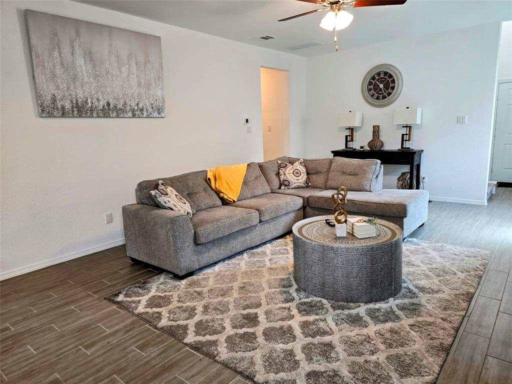 a living room with furniture and a rug