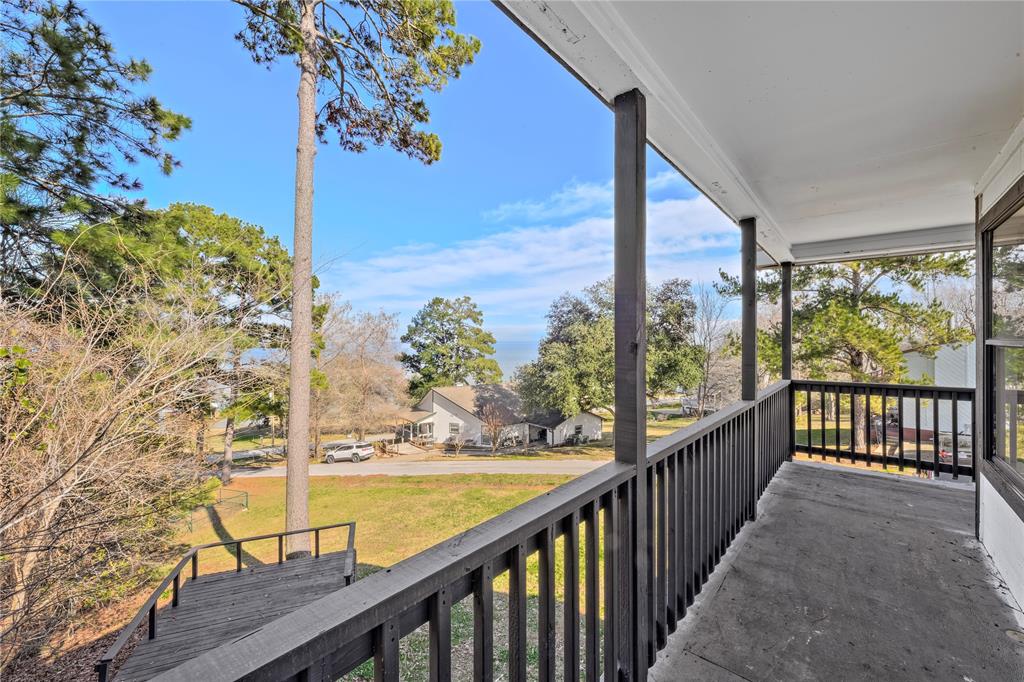 a view of balcony with wooden floor and fence