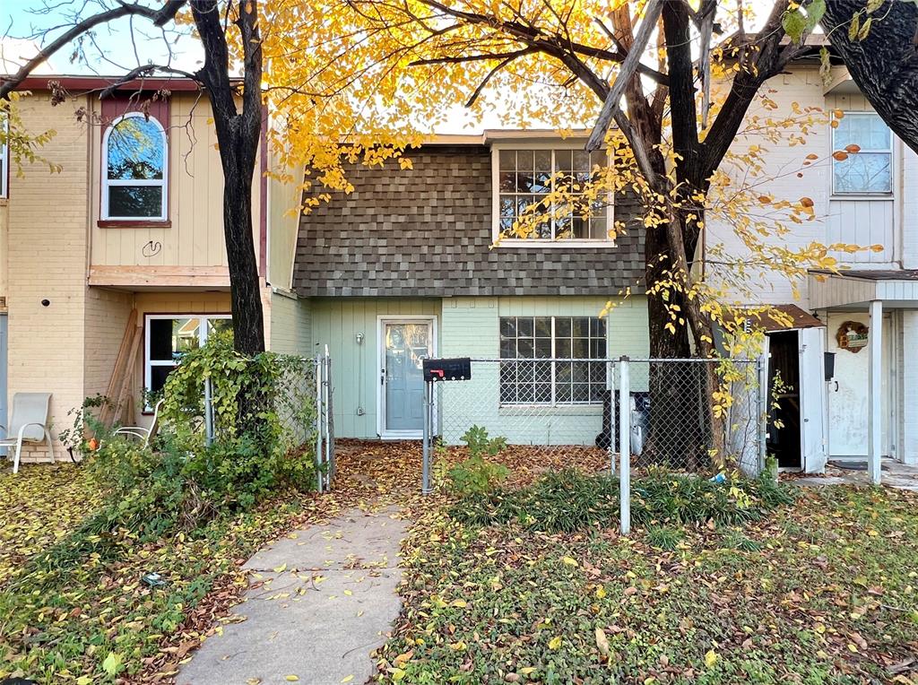 front view of a house with a tree