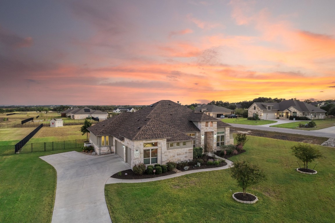 a view of a house with pool and a yard