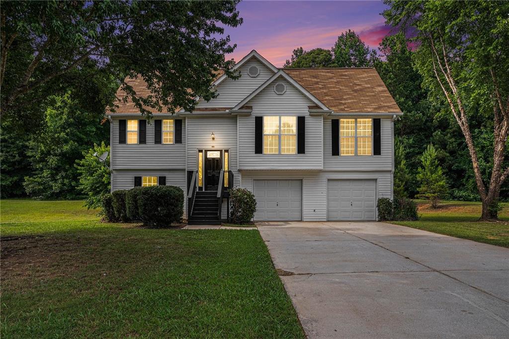 a front view of a house with a yard and garage