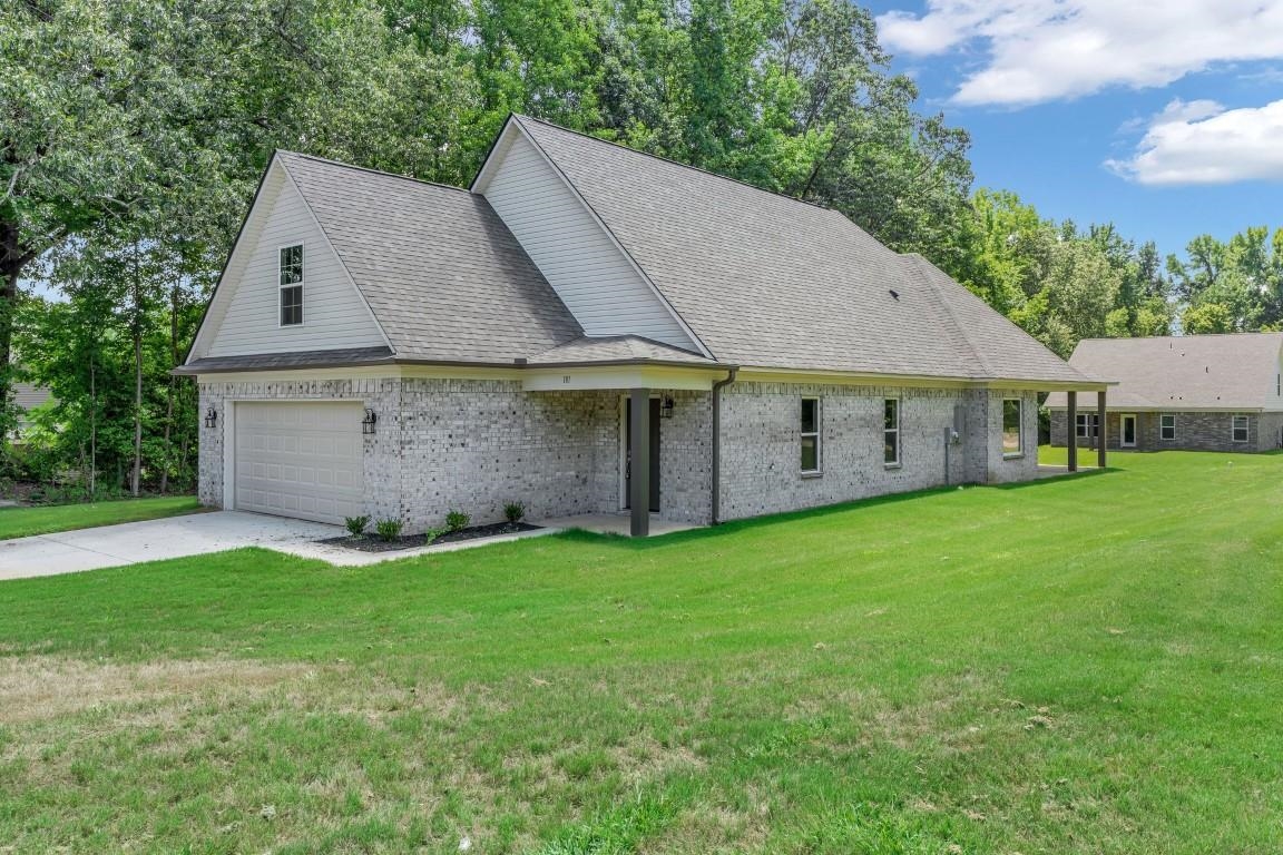 a aerial view of a house with a yard and a porch