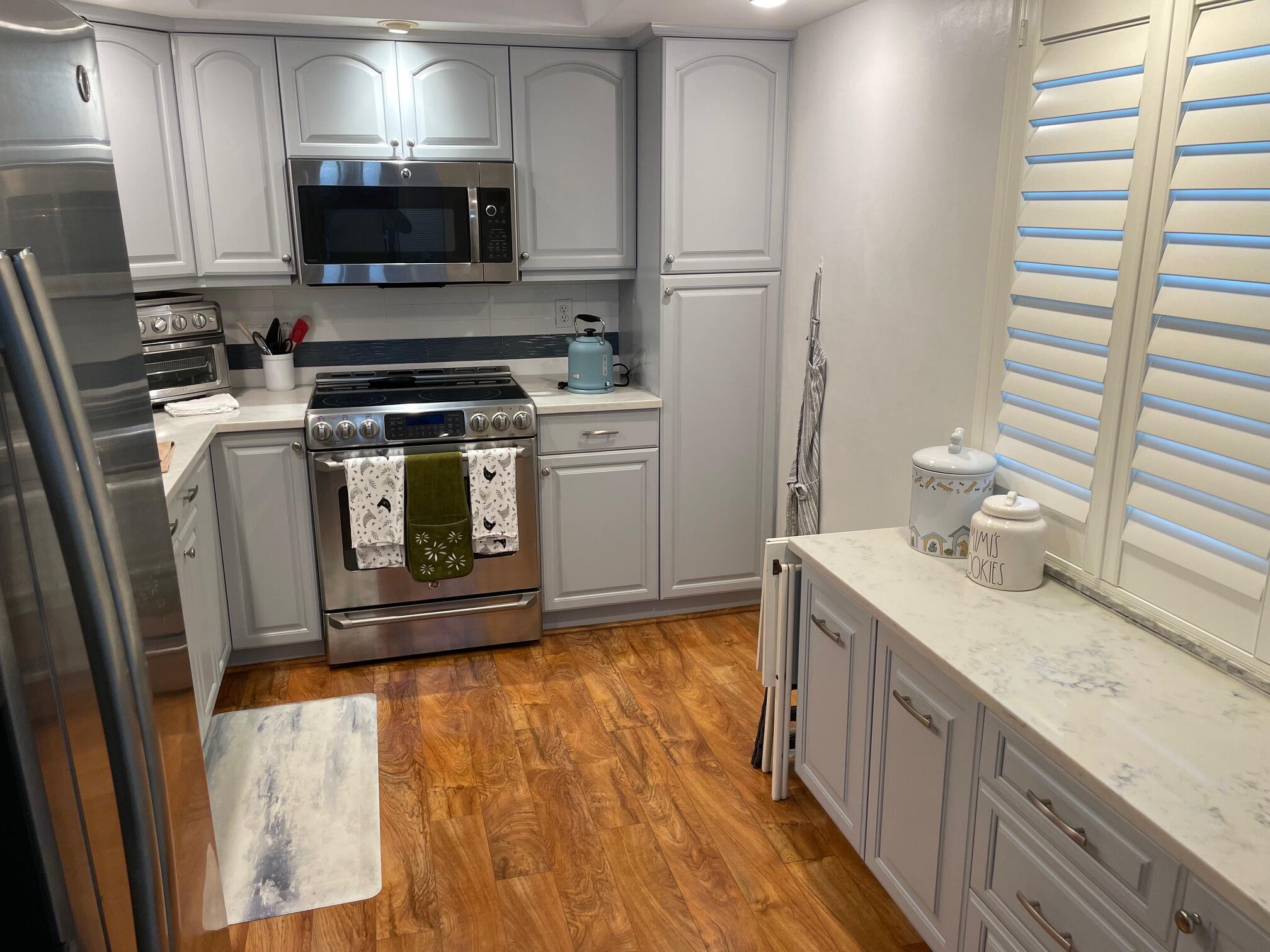 a kitchen with a sink stove and microwave