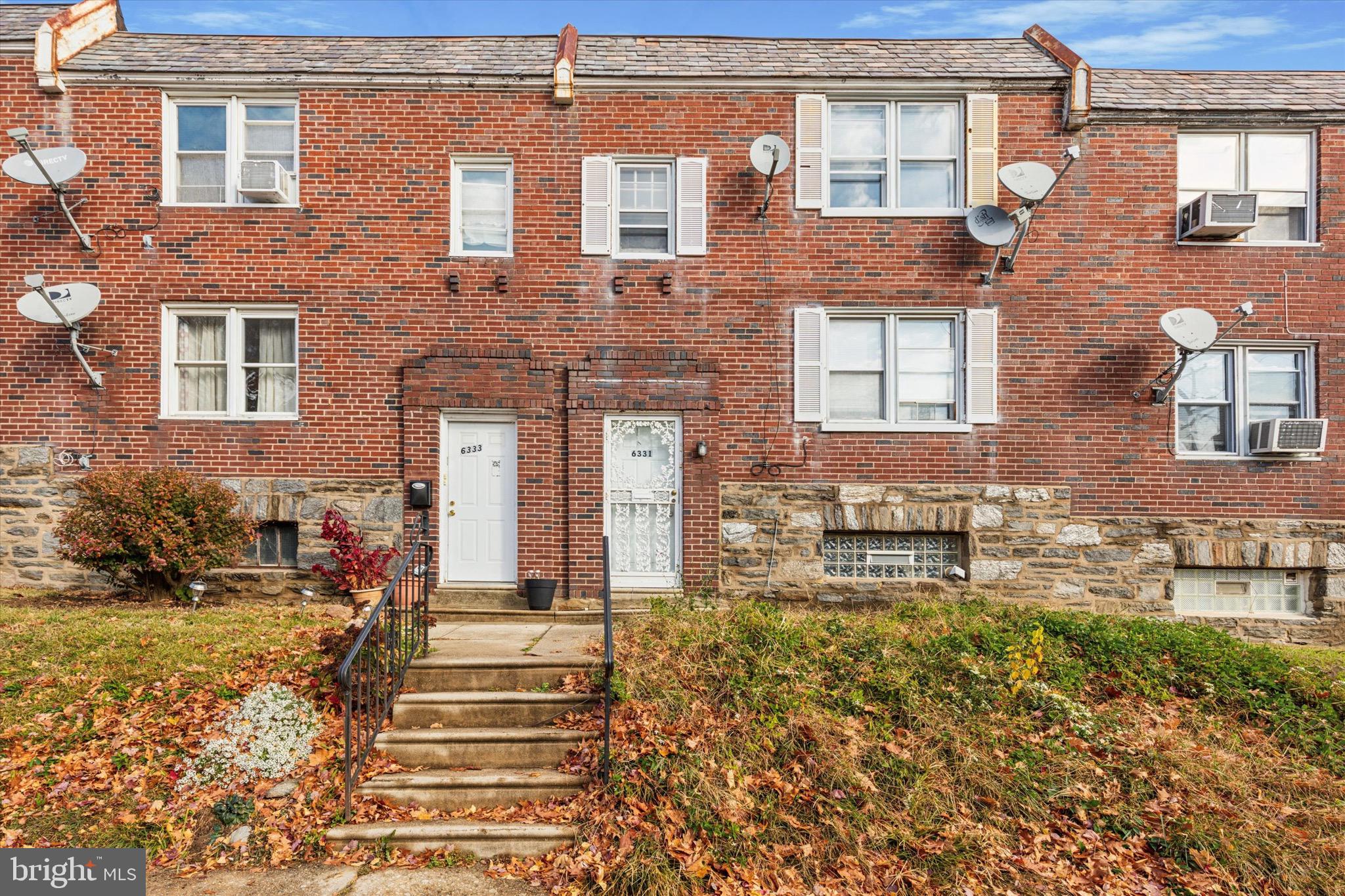 front view of a brick house with a yard