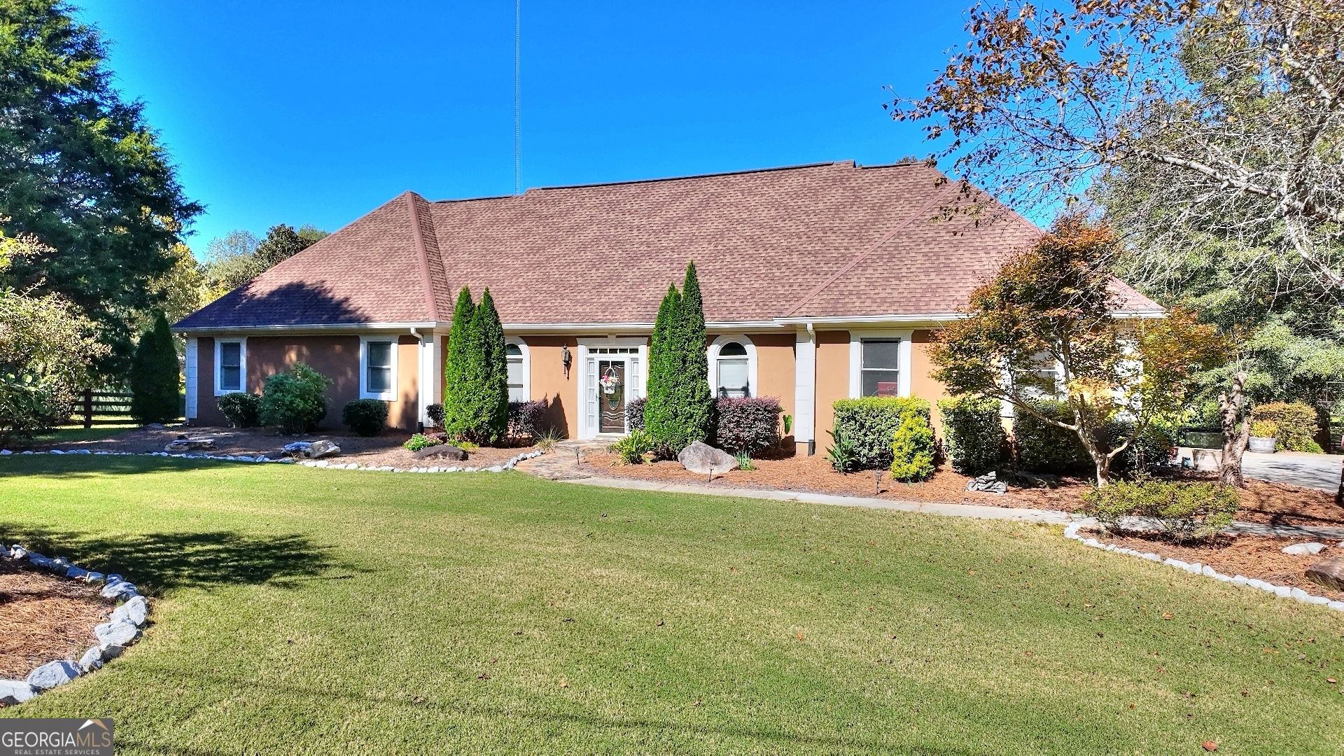 a view of a house with a yard and tree s