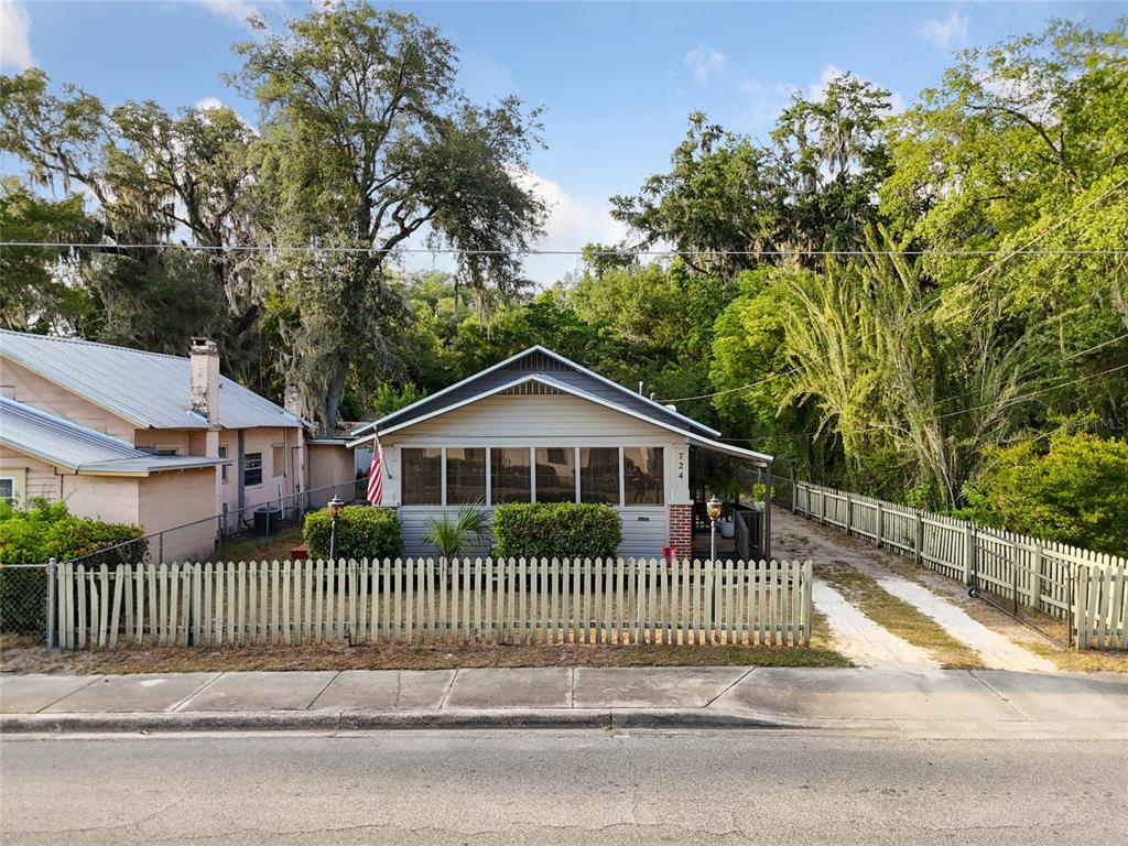 a view of a house with a deck and a yard