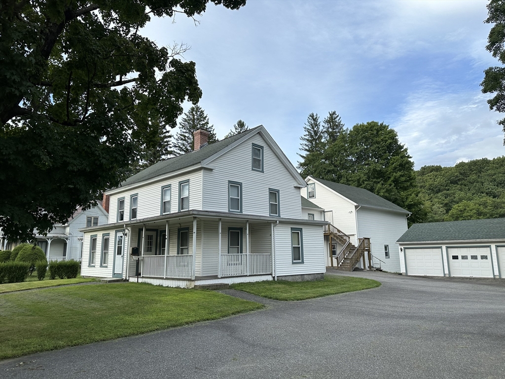 a view of house with a yard